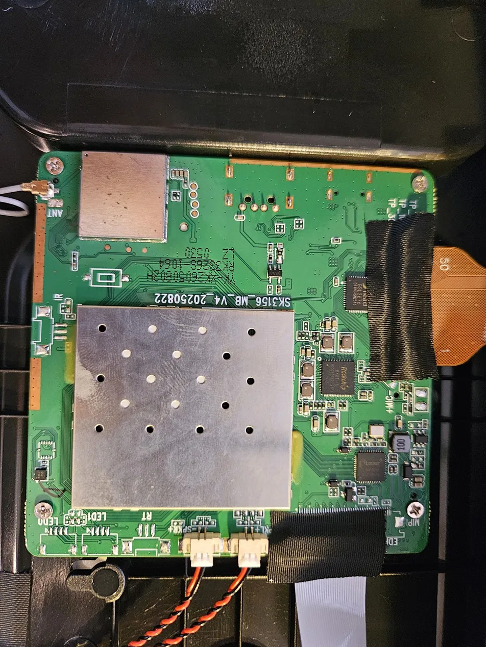 The frame's mainboard, with the eMMC and SoC under a shield - the “update button” is the pair of white concentric rectangles
